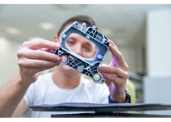 Quality engineer examines a sample scanned with a laser on a 3d scan in a research laboratory